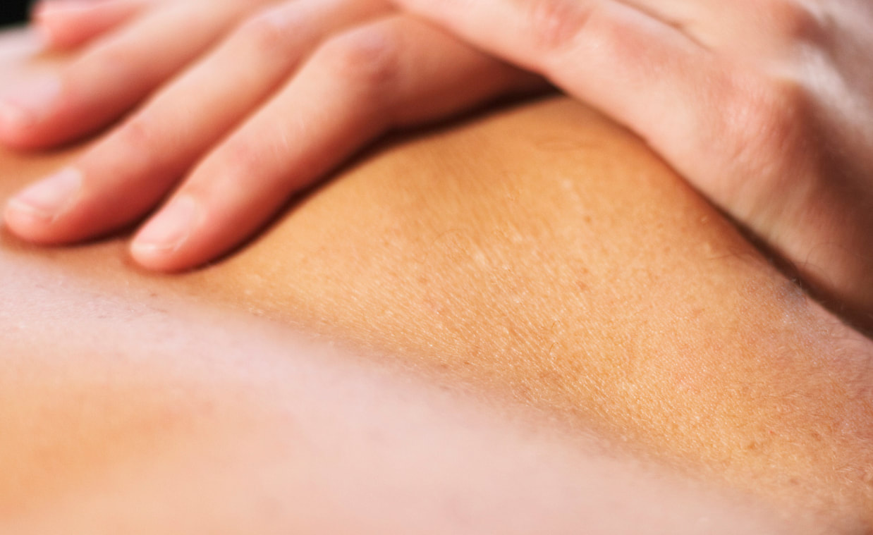 Hands massaging a back — the header photograph from Christian's current site.